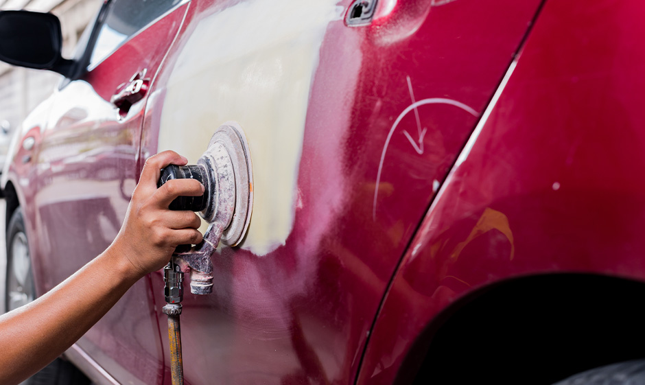 Side Door of a red car being fix for the damage Side Door of a red car being fix for the damage